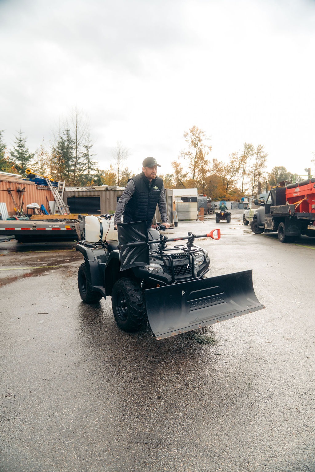 Man riding ATV with front snow plow