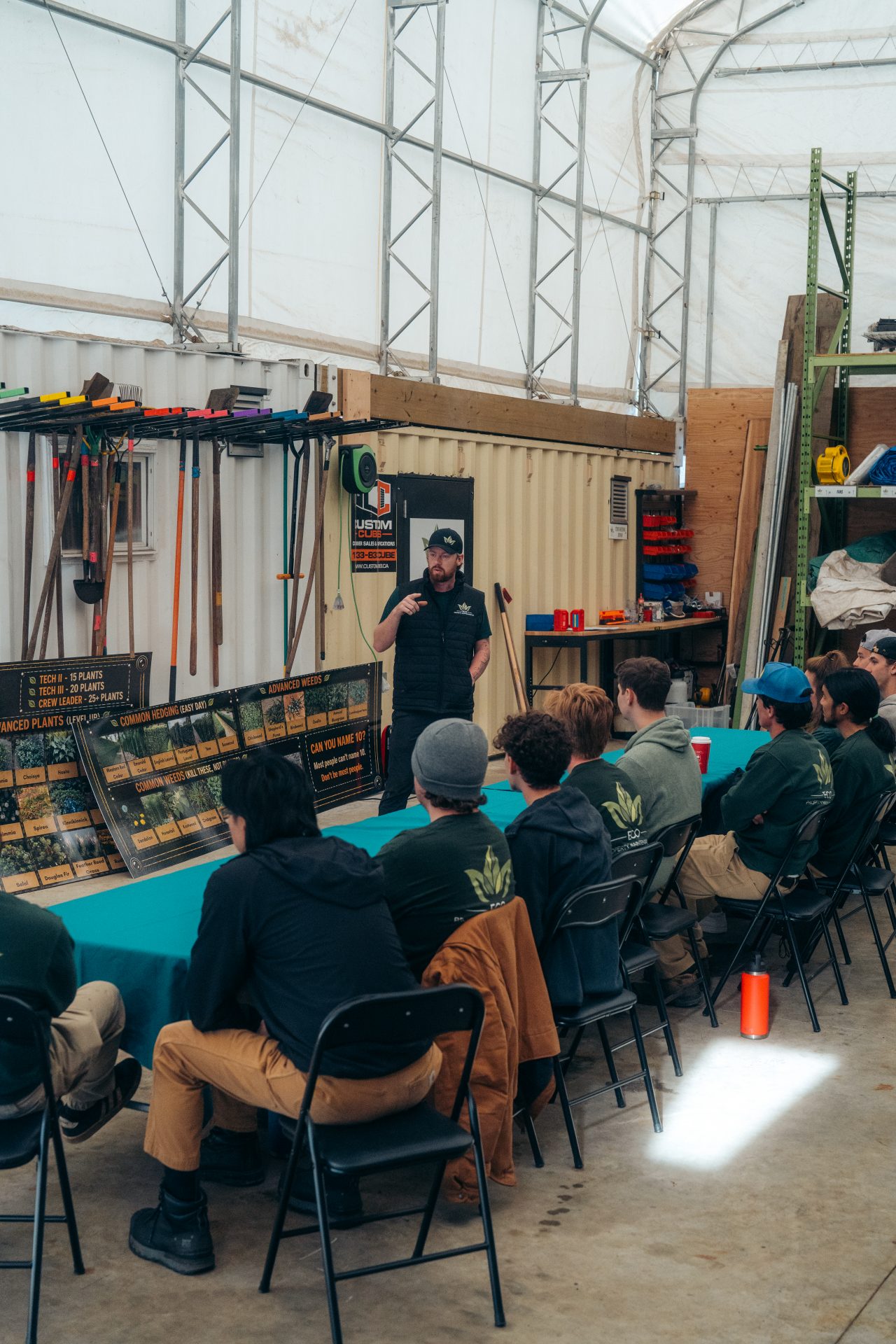 Instructor teaching plant identification workshop to group