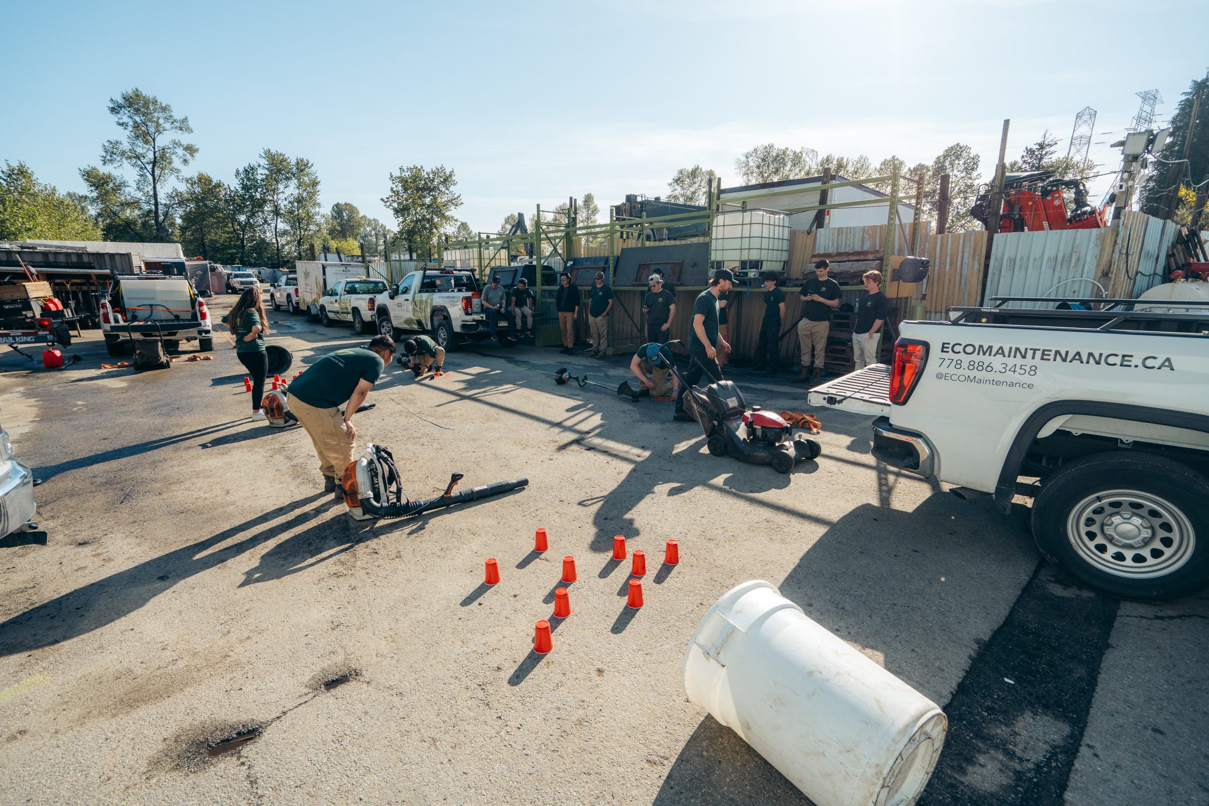 Landscaping crew training with equipment in yard