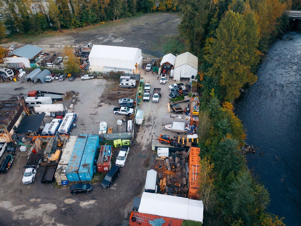 Aerial view of industrial yard beside river