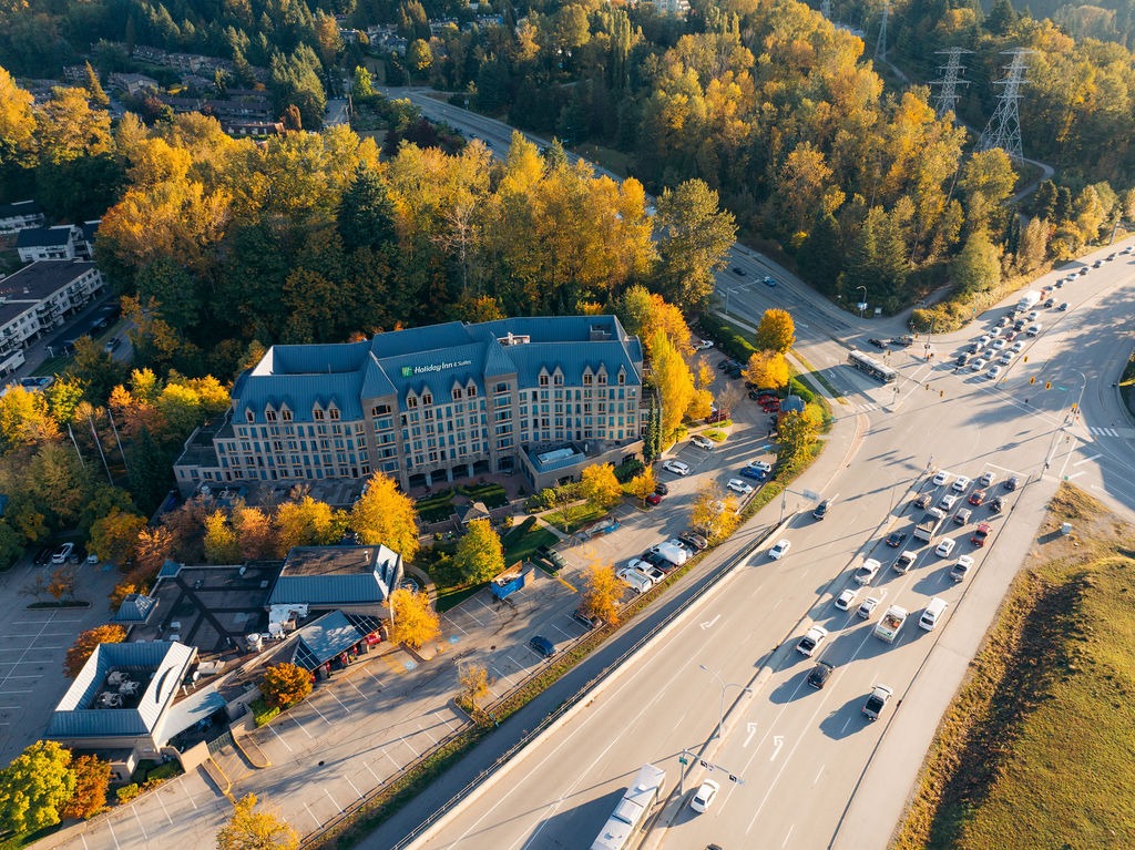 Aerial view of hotel beside busy highway in autumn