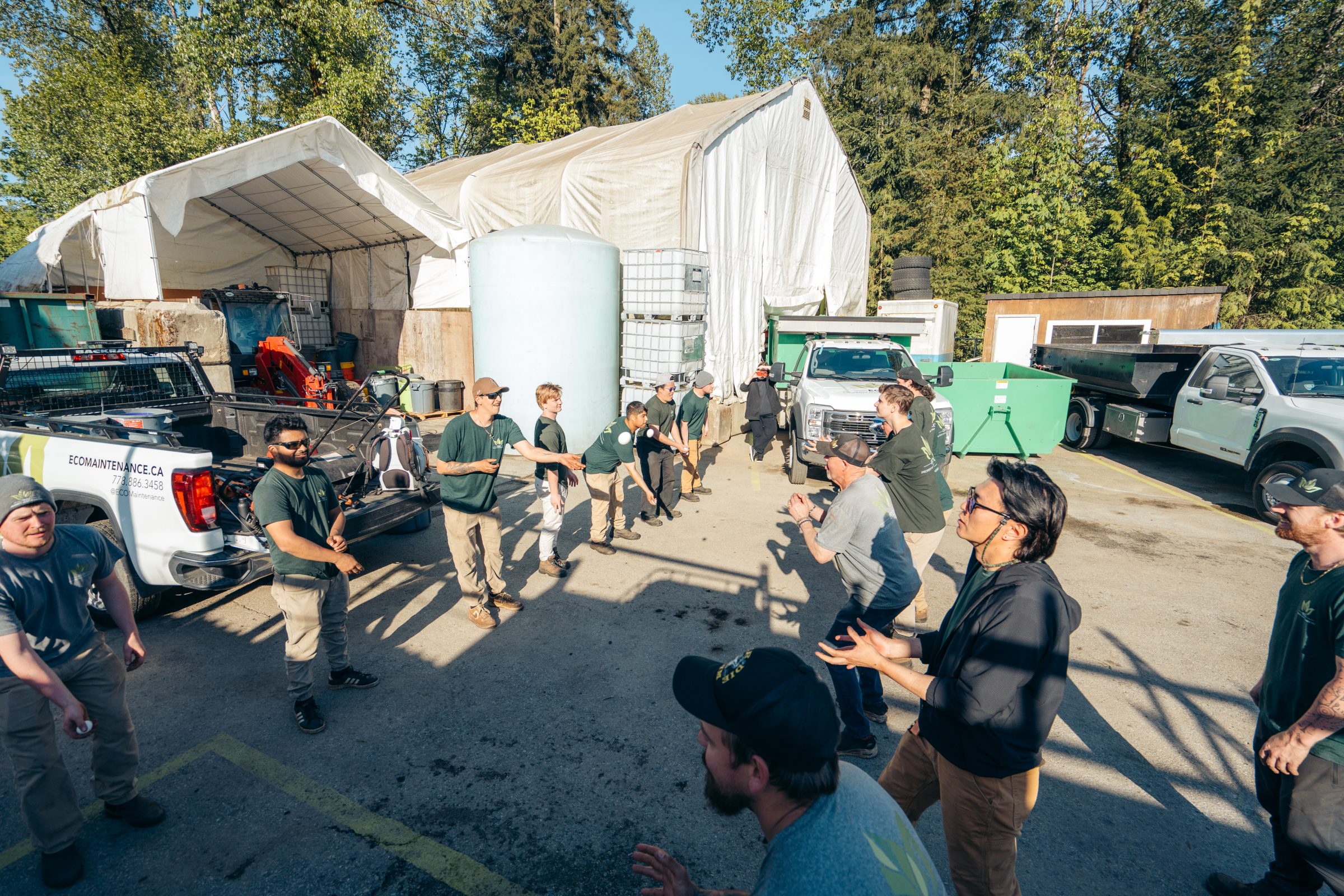 Crew playing catch in industrial yard