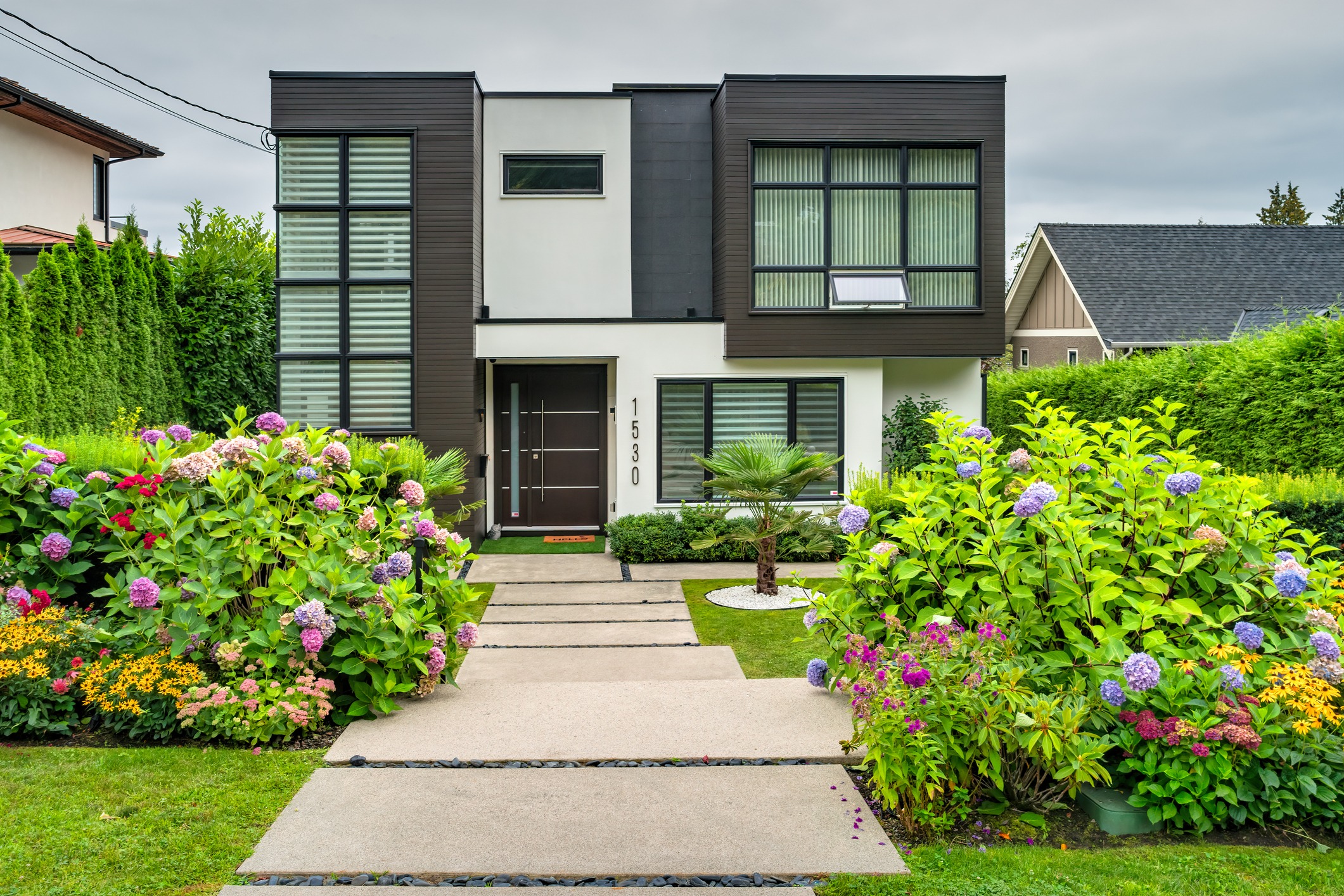 Modern two-story home with lush landscaped garden