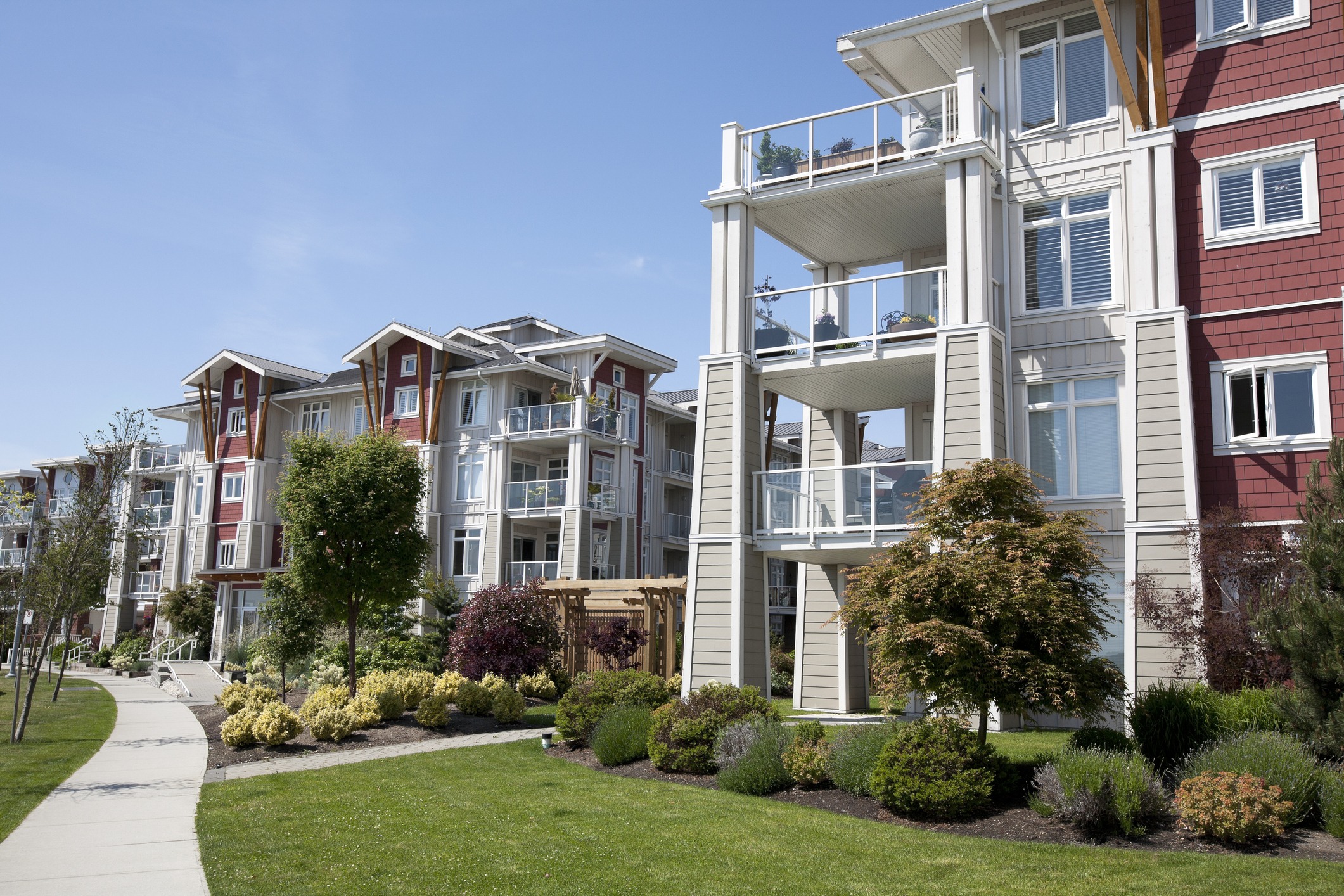 Modern apartment buildings with balconies and landscaped gardens