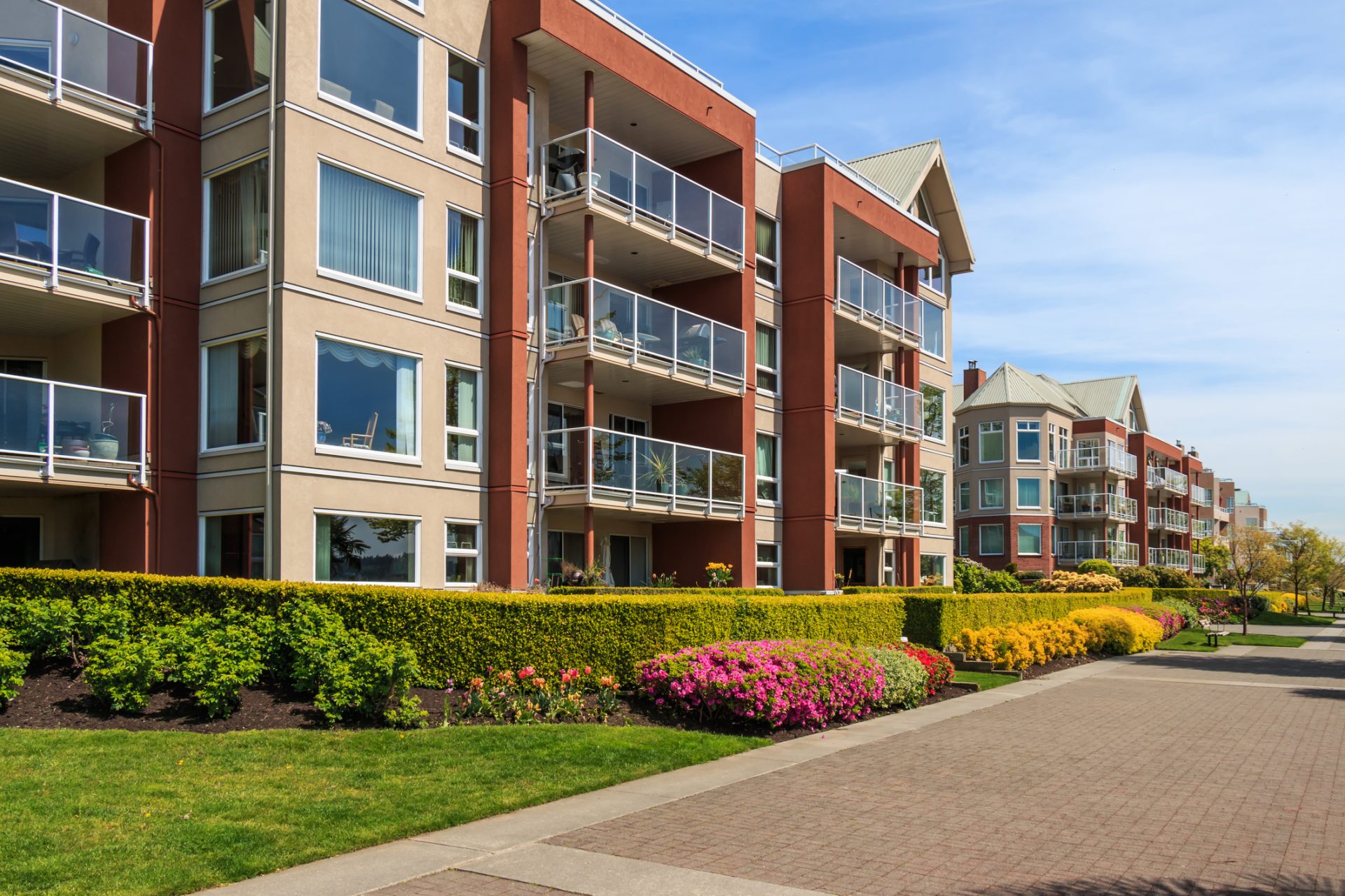 Modern condo buildings with balconies and landscaped gardens